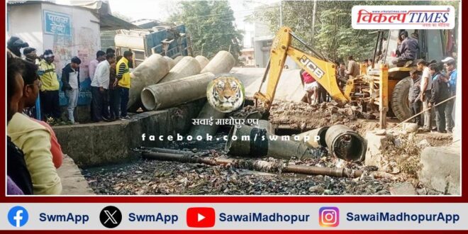 Truck filled with pipes overturned in drain due to culvert collapse