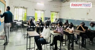 Students sitting in the classroom wearing helmets in kota